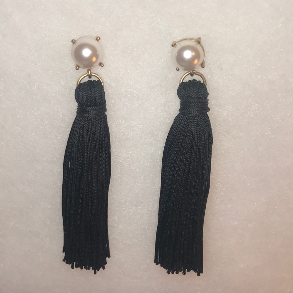 Pearl and black tassel earrings.
